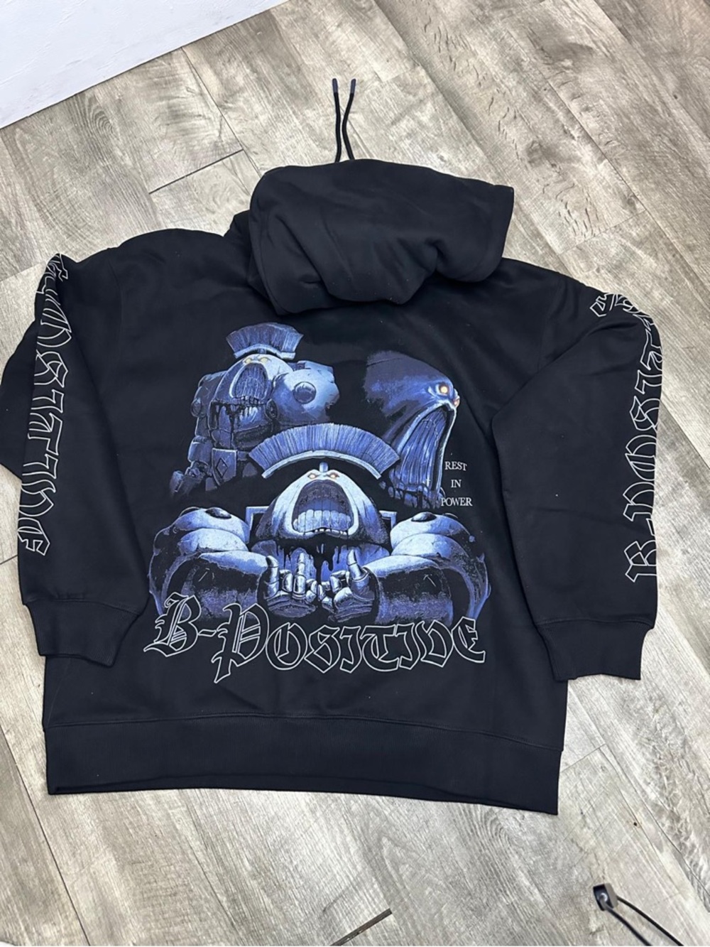 Black 'B Positive' Graphic Hoodie with Blue Skull Art
